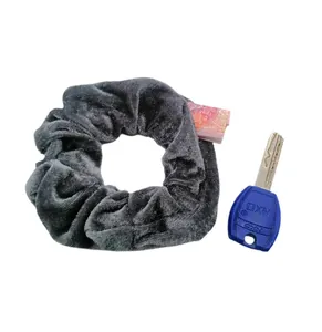 Detail of dark grey velvet scrunchie with functional hidden zipper pocket for small items