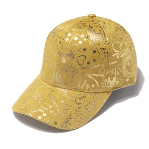 Golden baseball cap featuring metallic graffiti patterns with heart and love prints