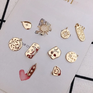 Gold plated celestial charms set featuring moon and star shapes with red enamel and zircons