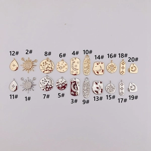 Detail view of 20 celestial gold and silver pendants with zircon for DIY jewelry making