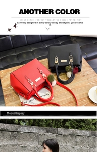 Detail of red and black lychee textured leather handbags with plush pom pom charms