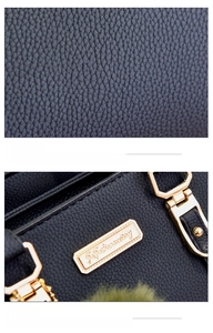 Detail of lychee pattern PU leather texture and shiny golden metal hardware logo plaque