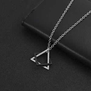 Men's geometric necklace featuring interlocking silver and black triangle pendants