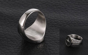 Detail of vintage star engraved signet ring with brushed titanium steel finish
