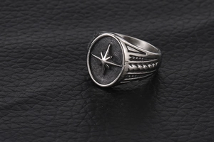 Macro shot of vintage titanium steel men's starburst signet ring with textured band
