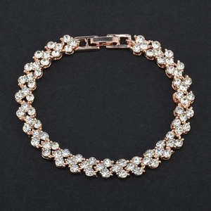 Detail of rose gold bracelet with multi-row zircon inlay on black textured background