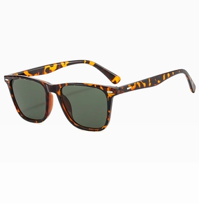 Detailed side view of tortoise shell sunglasses with dark green lenses and silver rivets