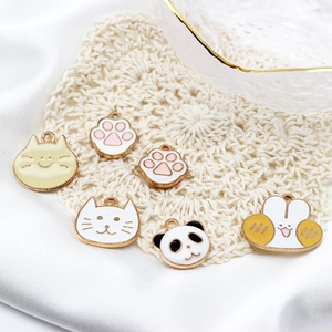 DIY jewelry pendants with enamel cartoon cat and panda heads on white lace background