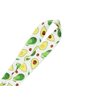 Close-up of white fruit-themed phone lanyard featuring cute avocado pattern details
