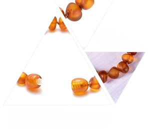 Detail of natural amber baby necklace featuring secure screw clasp and double-knotted beads