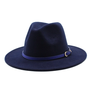 Detail of navy blue wool fedora hat featuring a stylish wide brim and golden buckle strap