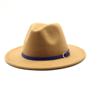 Close-up of camel wool fedora with navy blue leather band and gold metal buckle detail