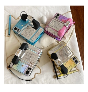 Detailed top view of retro telephone-style crossbody bags in four metallic colors