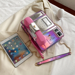 Creative holographic pink telephone-shaped crossbody bag with metallic chain and call me text