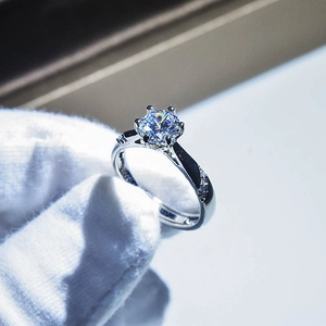 Macro view of a classic silver solitaire ring with side stone accents and sparkling center