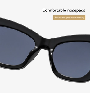 Close-up of comfortable wide nosepads on oversized black cat-eye sunglasses