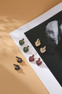 Detailed view of heart-shaped drop earrings with multicolor pavé zircon in four colors