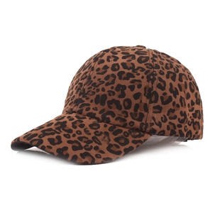 Detail view of stylish leopard print baseball cap with brown faux suede texture and curved brim
