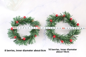 Close-up of artificial red berry wreaths with pine needles and diameter measurements