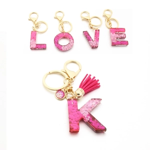Sparkly pink resin alphabet keychain with sequins, leather tassel and gold lobster clasp
