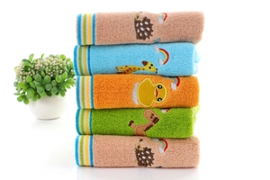 Detailed stack of colorful cotton children's towels featuring cute cartoon embroidery