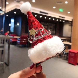 Close-up of a sequined Christmas hat hair clip with Merry Christmas badge and golden star