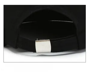Detailed view of adjustable silver metal buckle on black cotton street brimless cap
