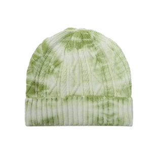 Close-up of green tie-dye knit beanie with cable knit texture and ribbed fold-over cuff