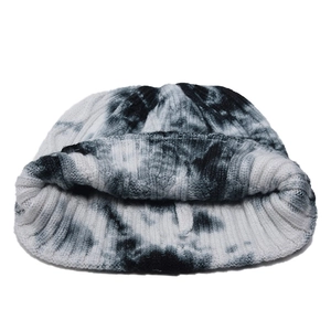 Women's black and white tie-dye knit beanie with thick ribbed texture and wide folded cuff