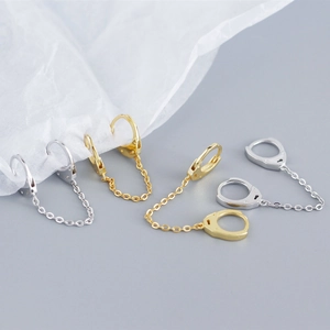 Detail of S925 sterling silver chain link hoop earrings in gold and silver finishes