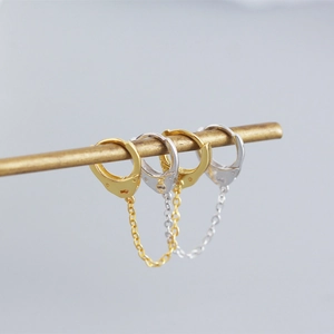 Close-up of S925 sterling silver handcuff link chain earrings in gold and silver