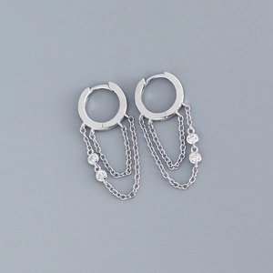 Detail of silver S925 earrings with geometric tassel chains and sparkling cubic zirconia