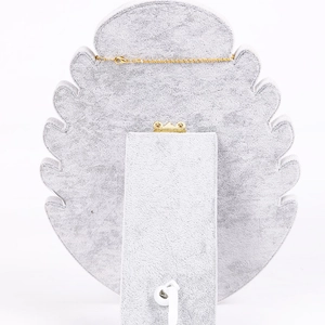 Detail view of the gray velvet jewelry display stand with a sturdy metal back hinge