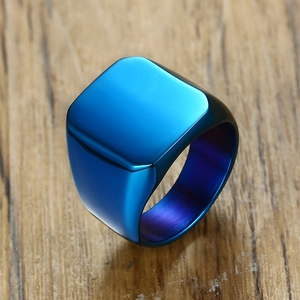Minimalist square stainless steel ring in matte blue finish on a wood surface