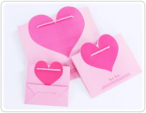 Three sizes of pink heart gift bags with romantic English quotes for special occasions