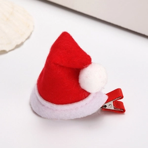 Cute red and white felt mini Christmas hat hair clip with a fluffy pompom for festive hair decor