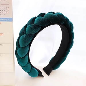 Close-up of deep green velvet braided headband with soft texture and premium handcraft