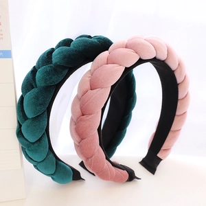 Detail of dark green and pink woven velvet headbands with handmade braided texture