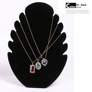 Three crystal necklaces on a black velvet display including heart and oval pendants
