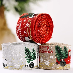 Three rolls of Christmas ribbons with car and tree patterns for holiday decor