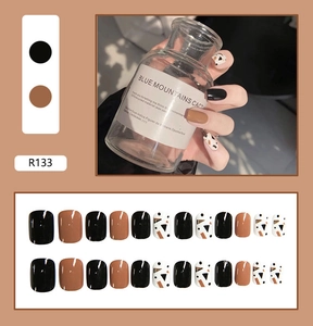 Detail view of R133 press-on nails set featuring black, camel, and geometric dot patterns