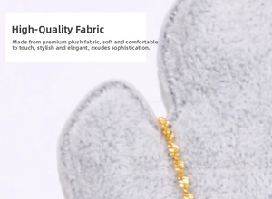 Macro detail of soft grey velvet jewelry display board with elegant gold chain trim