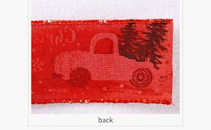 Macro shot of red Christmas truck ribbon showing woven fabric texture on the back side