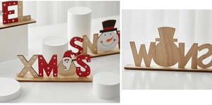 Detail of wooden XMAS and SNOW letters with painted snowman and Santa Claus figures