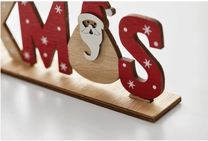 Close-up of wooden Xmas letters with painted Santa Claus and snowflake pattern details