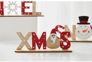 Close-up of wooden XMAS letters with Santa Claus and snowman motifs for desk decoration