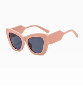 Detail view of cat eye sunglasses with trendy wide salmon frames and dark grey lenses