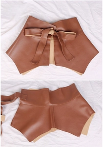 Detail of camel leather waist cincher with ruffle hem and bow tie decorative lace-up