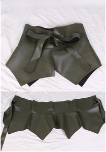 Close-up of army green PU leather corset belt with tie knot and ruffle hem detail