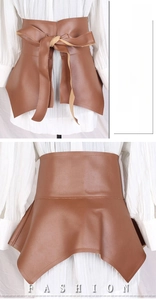Close-up of brown ruffled faux leather corset belt with lace-up back over white skirt